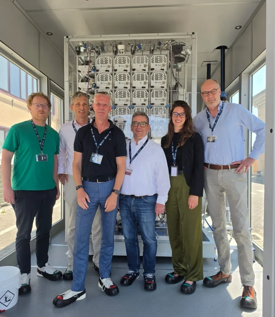 The team inside the Enapter Nexus 2500 electrolyser container